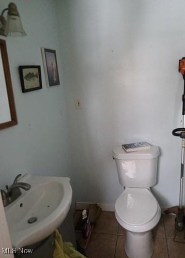 bathroom featuring tile patterned flooring, sink, and toilet