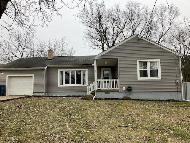 view of front of house with a garage and a front lawn