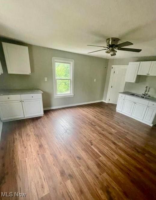 kitchen with hardwood / wood-style flooring, sink, white cabinets, and ceiling fan