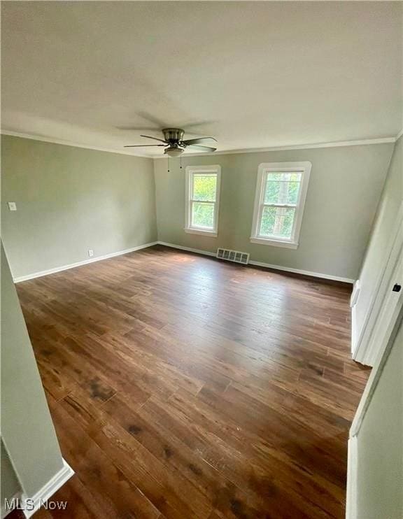 spare room featuring ornamental molding, dark hardwood / wood-style floors, and ceiling fan