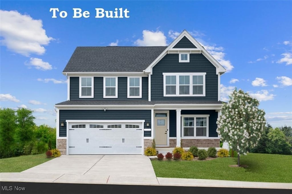 craftsman inspired home with a garage and a front lawn