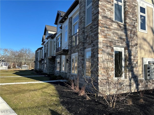 view of side of home featuring a lawn