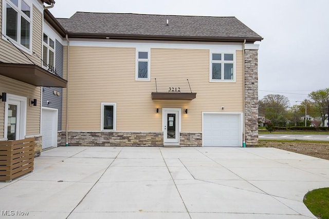 back of property with a garage