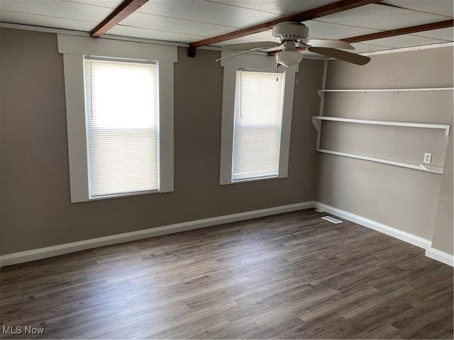 spare room featuring dark wood-type flooring and ceiling fan