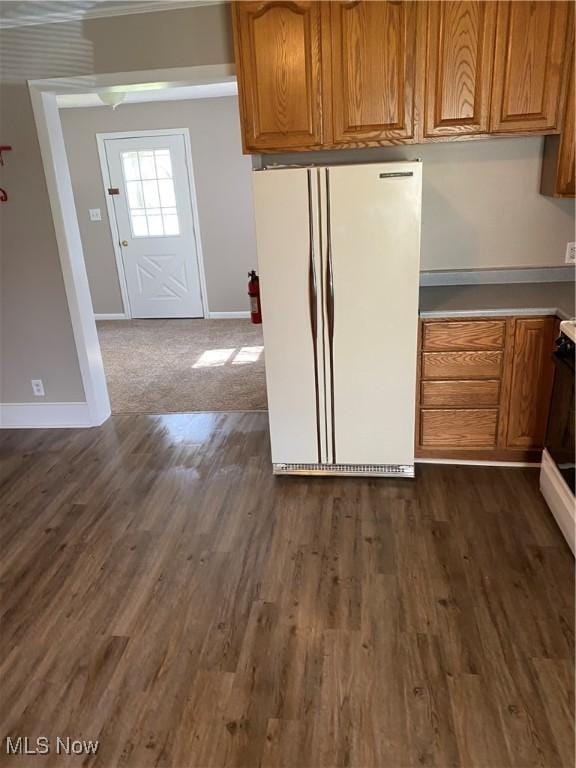 kitchen with white refrigerator and dark hardwood / wood-style flooring