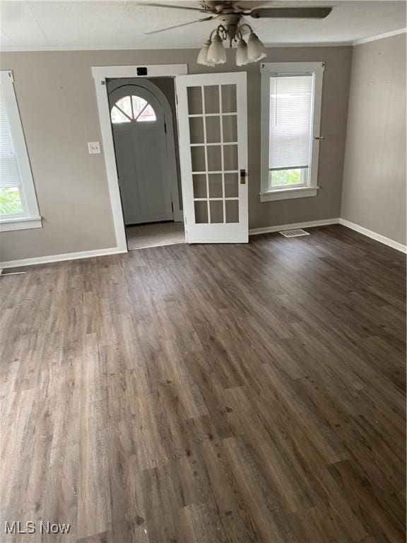 foyer featuring crown molding, dark wood-type flooring, and ceiling fan