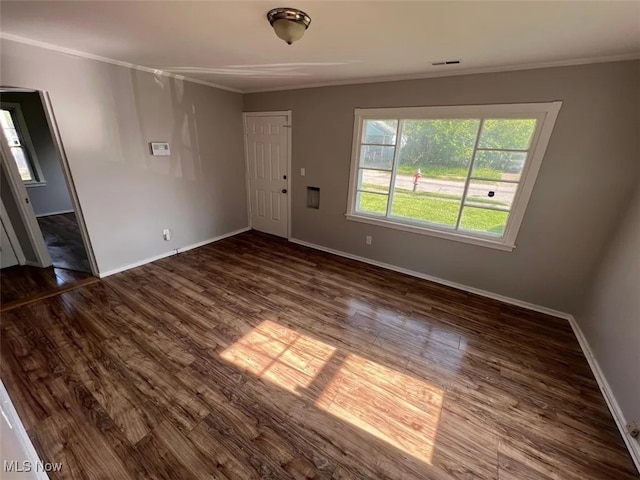 interior space with dark hardwood / wood-style flooring and ornamental molding