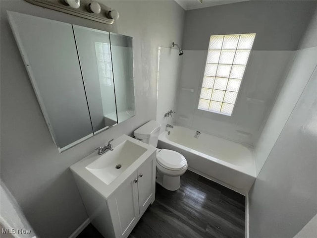 full bathroom with hardwood / wood-style flooring,  shower combination, toilet, and vanity