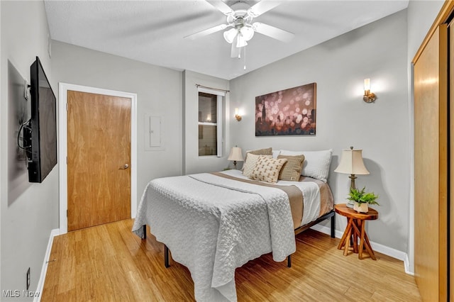 bedroom featuring light hardwood / wood-style floors and ceiling fan