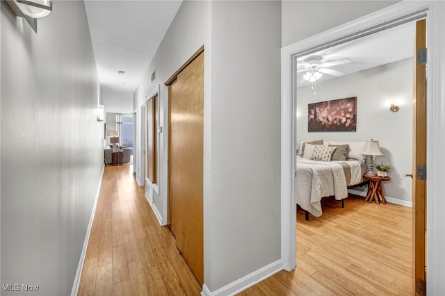 corridor with light hardwood / wood-style flooring