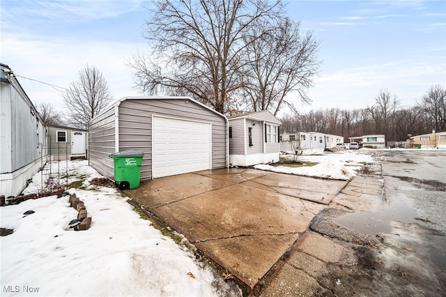 view of front of property featuring a garage and an outbuilding