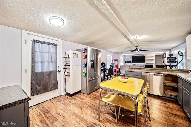 kitchen featuring appliances with stainless steel finishes, light hardwood / wood-style floors, a textured ceiling, and gray cabinetry