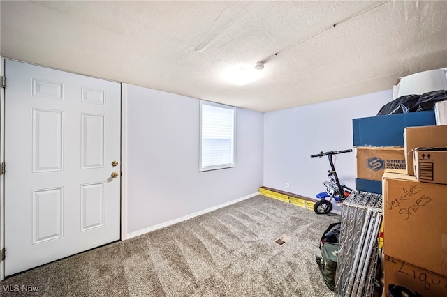 exercise room featuring carpet flooring and a textured ceiling