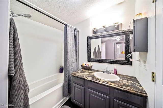 bathroom featuring vanity, shower / bath combination with curtain, and a textured ceiling