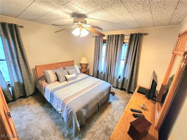 bedroom with ceiling fan and carpet flooring