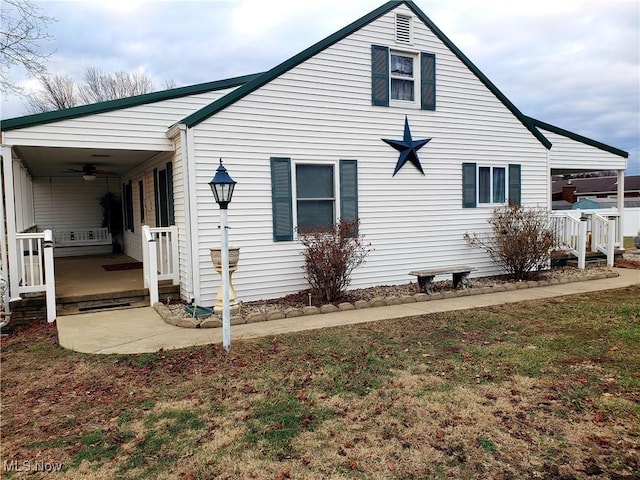 view of property exterior with a lawn, ceiling fan, and a porch