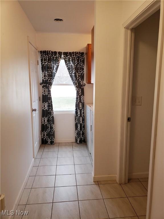 hallway with light tile patterned floors