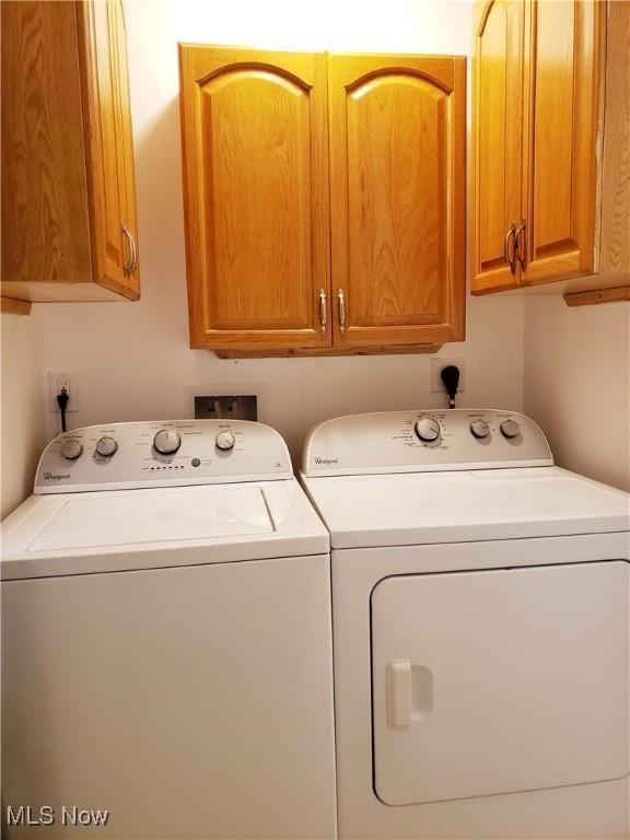 washroom featuring cabinets and independent washer and dryer