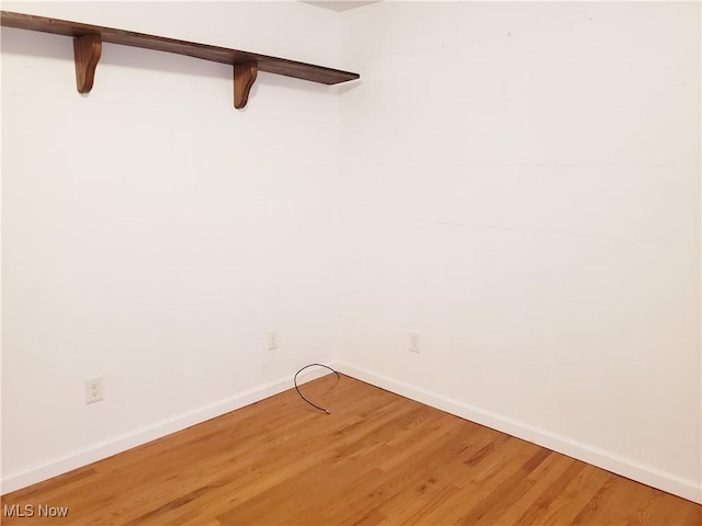 unfurnished room featuring hardwood / wood-style flooring