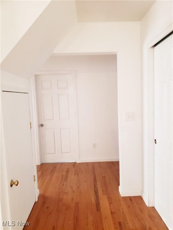 unfurnished bedroom featuring light wood-type flooring and a closet