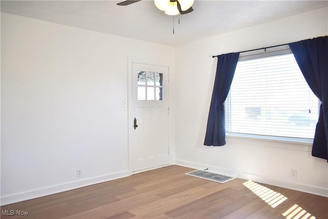 foyer with ceiling fan and light hardwood / wood-style floors