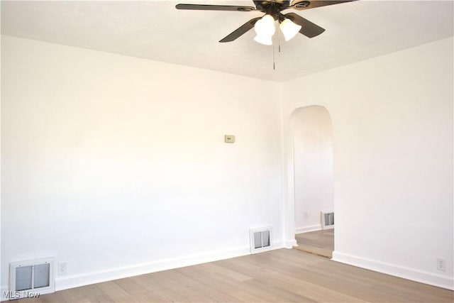 spare room featuring hardwood / wood-style floors and ceiling fan