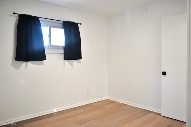 spare room with hardwood / wood-style flooring