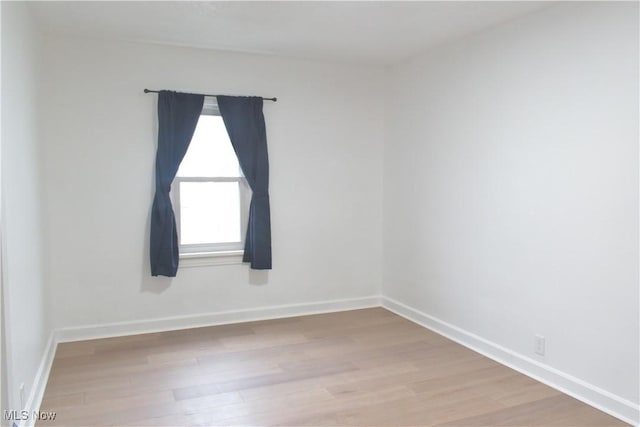 empty room with light hardwood / wood-style flooring