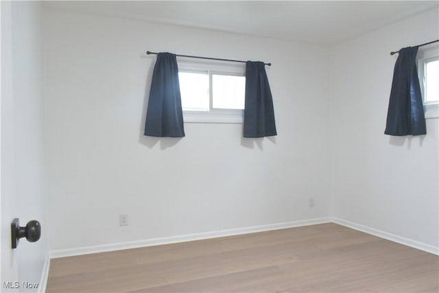 spare room featuring hardwood / wood-style flooring