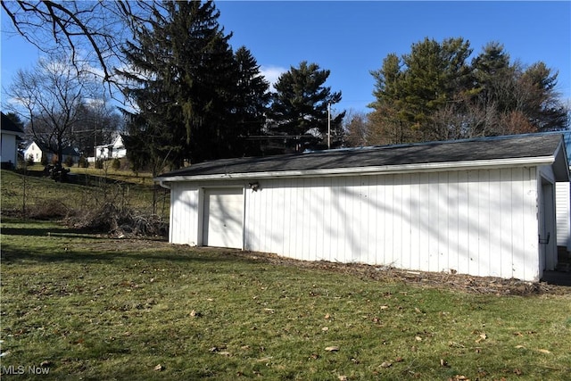 view of property exterior with an outbuilding and a yard