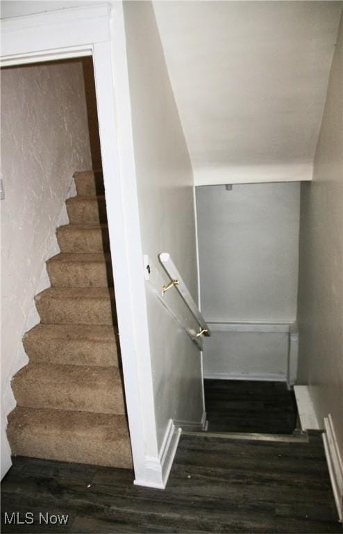 stairs featuring wood-type flooring