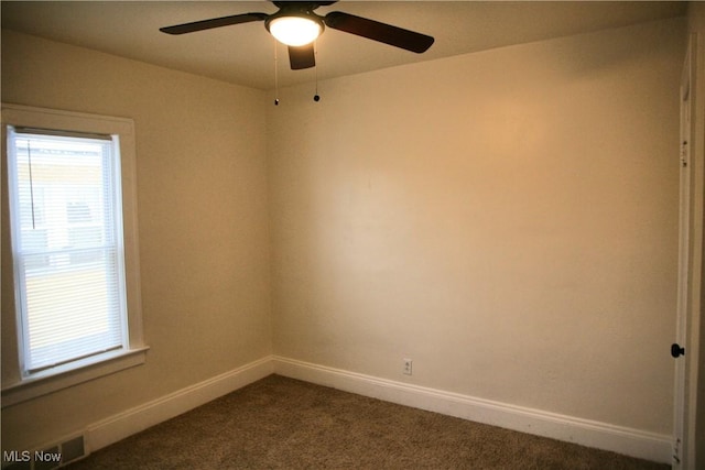 empty room with ceiling fan and carpet flooring