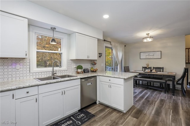 kitchen with white cabinetry, decorative light fixtures, dishwasher, and sink