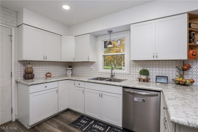 kitchen with sink, white cabinetry, hanging light fixtures, decorative backsplash, and stainless steel dishwasher