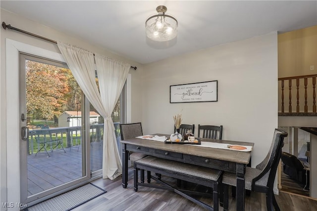 dining space with hardwood / wood-style floors