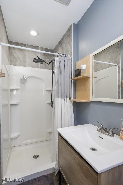 bathroom featuring vanity and a shower with shower curtain