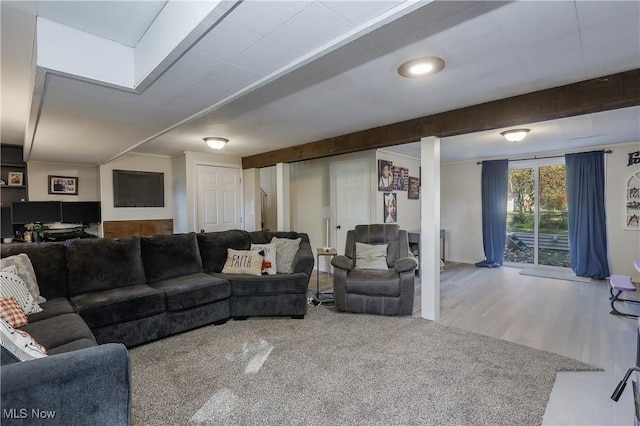 living room featuring wood-type flooring and beam ceiling