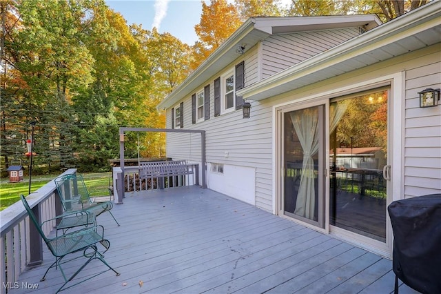 wooden terrace with a grill