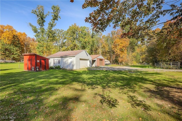 view of yard with a garage and an outdoor structure