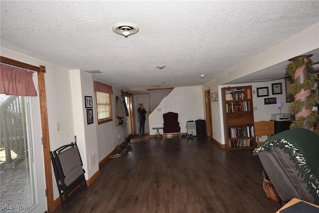 interior space featuring a textured ceiling and dark hardwood / wood-style flooring