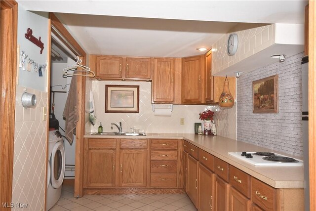 kitchen featuring light tile patterned floors, sink, decorative backsplash, and white electric stovetop