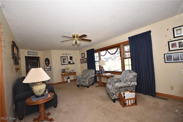 living area featuring a textured ceiling and carpet