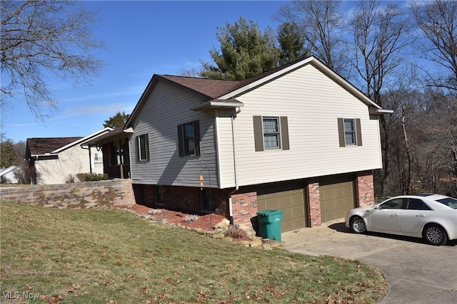 view of side of home featuring a garage and a lawn