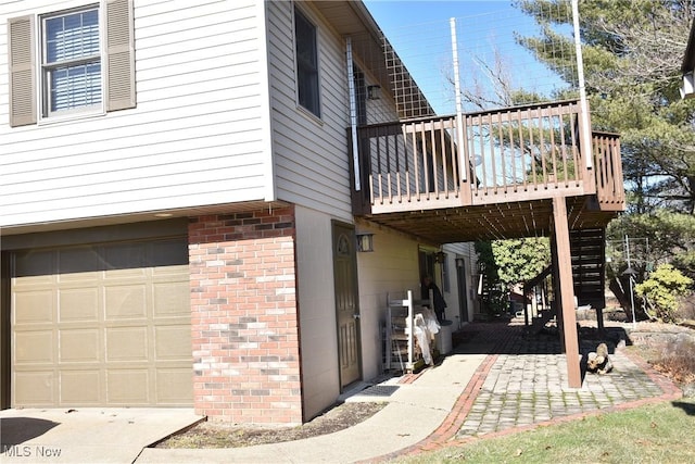 view of home's exterior with a wooden deck and a garage