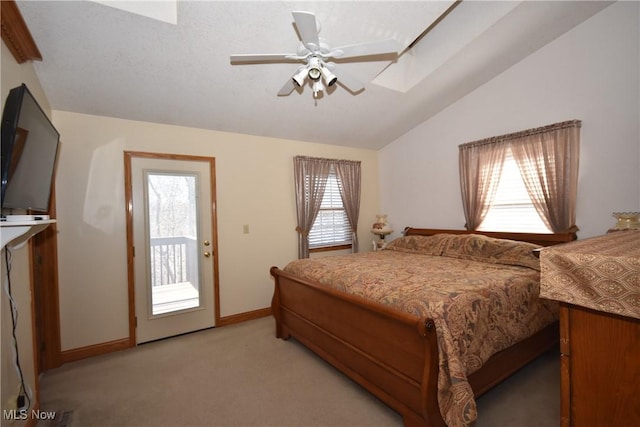 carpeted bedroom with access to outside, ceiling fan, and vaulted ceiling