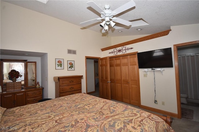 bedroom with vaulted ceiling, a textured ceiling, a closet, ceiling fan, and carpet