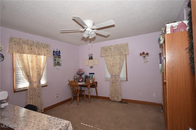 carpeted bedroom with ceiling fan and a textured ceiling