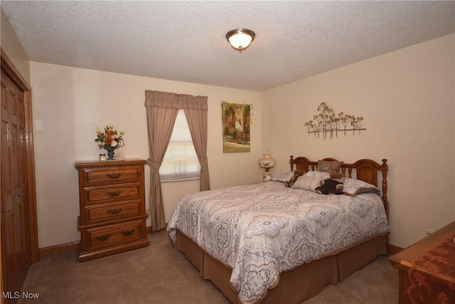 carpeted bedroom with a textured ceiling