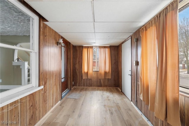 spare room with wooden walls and light hardwood / wood-style floors