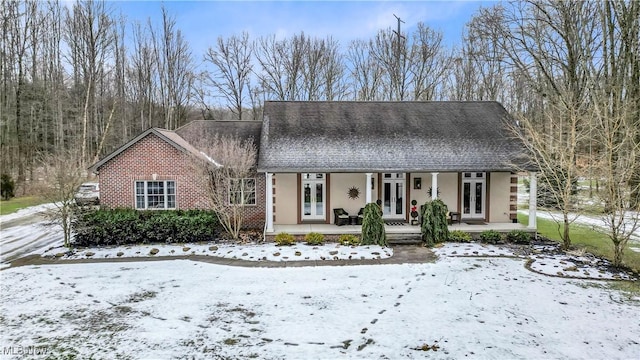 view of front of house with a porch and french doors